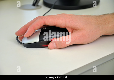 Man`s hand on computer mouse, close-up Stock Photo